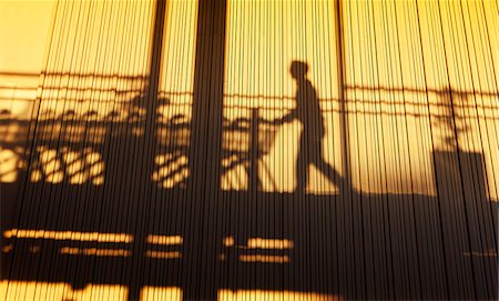 department store interior - Silhouette of person pulling shopping trolleys Stock Photo - Premium Royalty-Free, Code: 6102-06471165