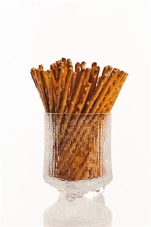 Glass of salty sticks on white background Stock Photo - Premium Royalty-Free, Code: 6102-06471180