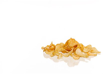 potatochips - Crisps on white background Stock Photo - Premium Royalty-Free, Code: 6102-06471181