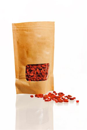 red brown - Dried goji berries in bag, studio shot Stock Photo - Premium Royalty-Free, Code: 6102-06471192