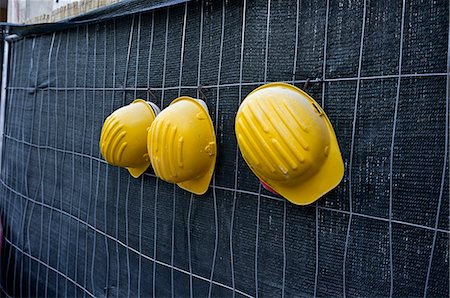 Three yellow hardhats hanging Stock Photo - Premium Royalty-Free, Code: 6102-06471280