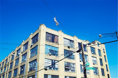 power pylons - Low angle view of electric pole and building Stock Photo - Premium Royalty-Free, Code: 6102-06471237