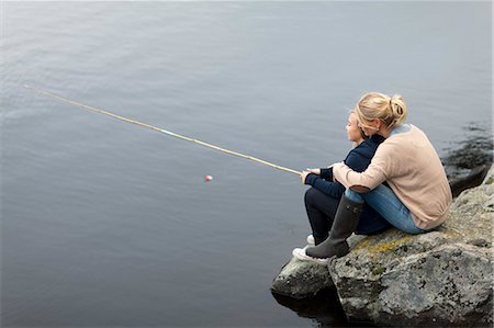 fishing women photos - Daughter and mother fishing at lake Stock Photo - Premium Royalty-Free, Code: 6102-06777363