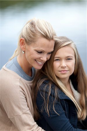 Portrait of mother and daughter by lake Stock Photo - Premium Royalty-Free, Code: 6102-06777377