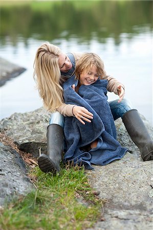 Mother drying son with towel at lake Stock Photo - Premium Royalty-Free, Code: 6102-06777399