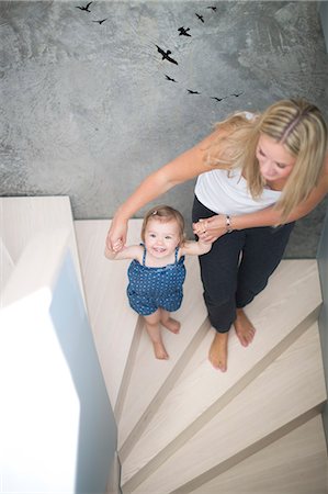 Mother and daughter walking on steps Stock Photo - Premium Royalty-Free, Code: 6102-06777448