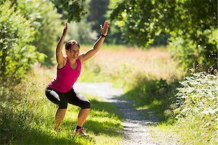 simsearch:6102-07769358,k - Woman stretching in park Stock Photo - Premium Royalty-Free, Code: 6102-06777491