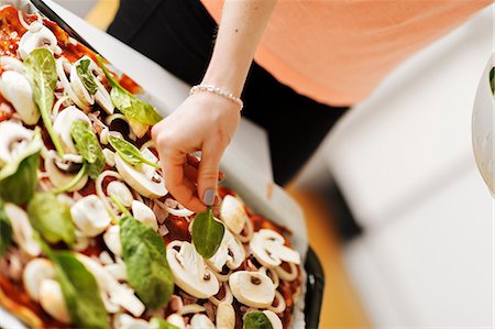 simsearch:6102-06777551,k - Woman preparing pizza, close-up Stock Photo - Premium Royalty-Free, Code: 6102-06777552