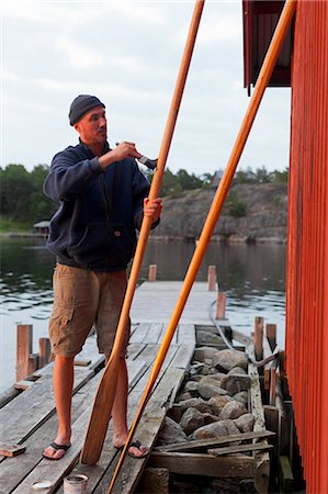 Man painting oar Foto de stock - Sin royalties Premium, Código: 6102-06965522