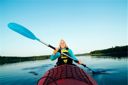 female canoeing - Smiling woman holding paddle Stock Photo - Premium Royalty-Free, Code: 6102-06965742