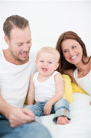 family playing bed laughing - Happy parents playing with son on bed Stock Photo - Premium Royalty-Free, Code: 6102-07158096