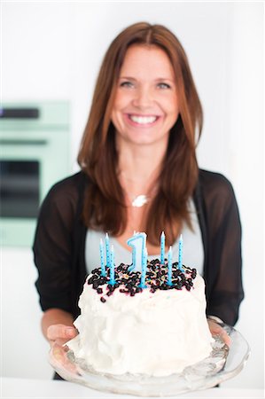 Woman preparing birthday cake Stock Photo - Premium Royalty-Free, Code: 6102-07158115