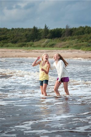 simsearch:6102-03827802,k - Two happy girls at sea, Sweden Stock Photo - Premium Royalty-Free, Code: 6102-07282619