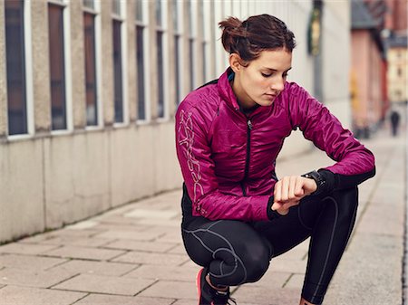 running in europe - Young runner looking at watch Stock Photo - Premium Royalty-Free, Code: 6102-07455759