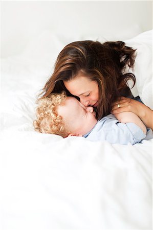 smaland sweden home - Mother playing with son on bed Stock Photo - Premium Royalty-Free, Code: 6102-07455784