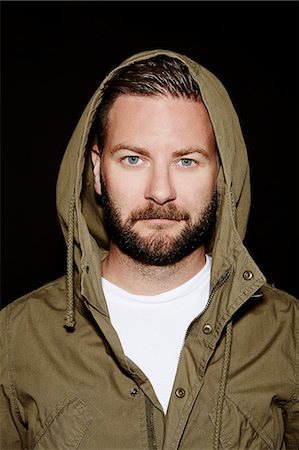 eye contact man portrait - Portrait of mid adult man on black background Stock Photo - Premium Royalty-Free, Code: 6102-07455816