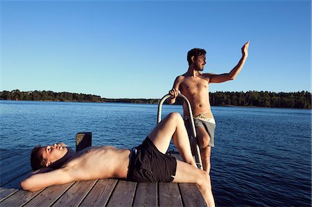 sunbathing with friends - Two young men on jetty, Sweden Stock Photo - Premium Royalty-Free, Code: 6102-07521554