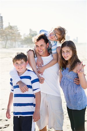 Father with children on beach Stock Photo - Premium Royalty-Free, Code: 6102-07521599