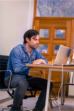 Mid adult man working in office, Gothenburg, Sweden Stock Photo - Premium Royalty-Free, Code: 6102-07602588