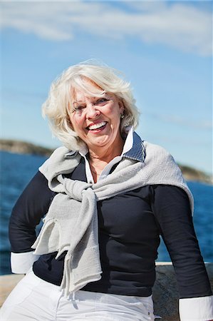 simsearch:6102-07602696,k - Senior woman looking at camera, Grundsund, Bohuslan, Sweden Fotografie stock - Premium Royalty-Free, Codice: 6102-07602692