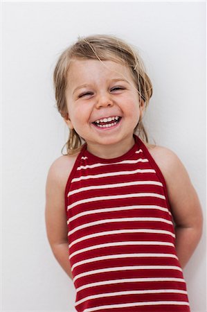 portrait expressions - Portrait of laughing girl, studio shot Stock Photo - Premium Royalty-Free, Code: 6102-07602750