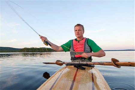 Young man fishing, Sweden Stock Photo - Premium Royalty-Free, Code: 6102-07602873