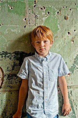 standing a single boy - Boy against wall, Sodermanland, Sweden Stock Photo - Premium Royalty-Free, Code: 6102-07768359