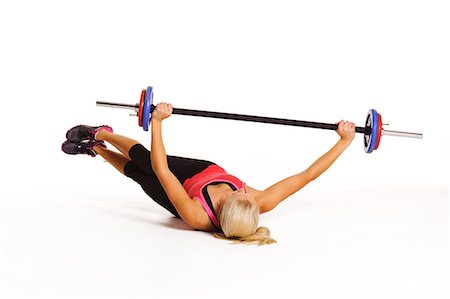 simsearch:6102-07768425,k - Woman exercising with barbell, studio shot Photographie de stock - Premium Libres de Droits, Code: 6102-07768403