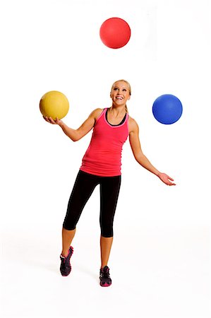 Woman juggling balls, studio shot Foto de stock - Sin royalties Premium, Código: 6102-07768405
