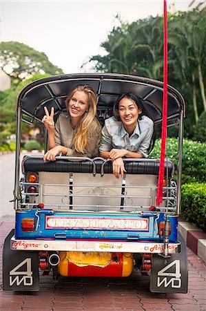 friends on vacation - Young women in rickshaw, Bangkok, Thailand Stock Photo - Premium Royalty-Free, Code: 6102-07768958