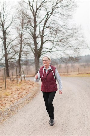 seniors running outdoors - Senior woman jogging Stock Photo - Premium Royalty-Free, Code: 6102-07769124