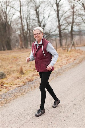 Senior woman jogging Stock Photo - Premium Royalty-Free, Code: 6102-07769126