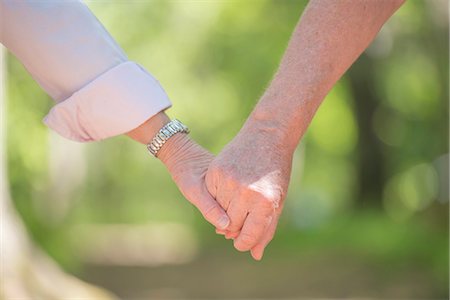 Senior couple holding hands, close-up Stock Photo - Premium Royalty-Free, Code: 6102-07769274
