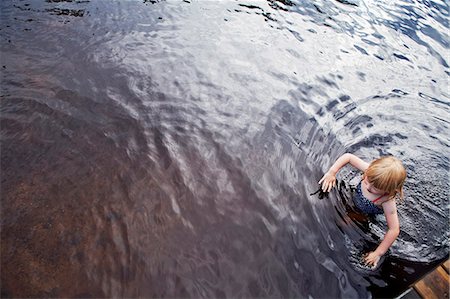 swimming in lake summer - Girl in water, high angle view Stock Photo - Premium Royalty-Free, Code: 6102-07769208