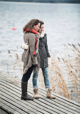 parents hug - Mother and teenage daughter looking at water Stock Photo - Premium Royalty-Free, Code: 6102-07769388