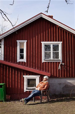 simsearch:6102-07843299,k - Mid adult man resting in front of house Stock Photo - Premium Royalty-Free, Code: 6102-07769449