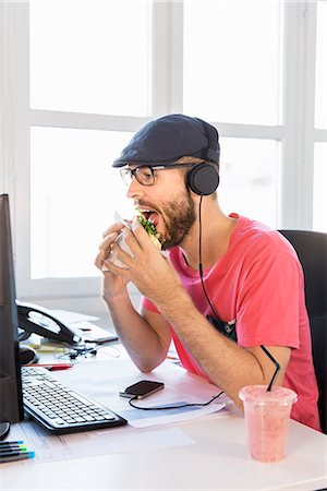 stressed professional - Mid adult man working in office Stock Photo - Premium Royalty-Free, Code: 6102-07789687