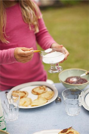 pancake top view - Girl putting sugar on pancakes Stock Photo - Premium Royalty-Free, Code: 6102-07789807