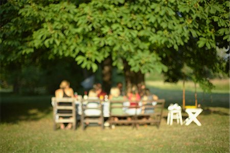 evening boy and girls images - People having meal in garden Stock Photo - Premium Royalty-Free, Code: 6102-07790053