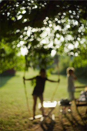Children playing in garden Stock Photo - Premium Royalty-Free, Code: 6102-07790051