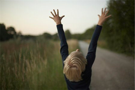 Boy with arms raised Stock Photo - Premium Royalty-Free, Code: 6102-07790024