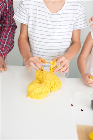 Boy with father and sister preparing dough for saffron rolls Stock Photo - Premium Royalty-Free, Code: 6102-07842715