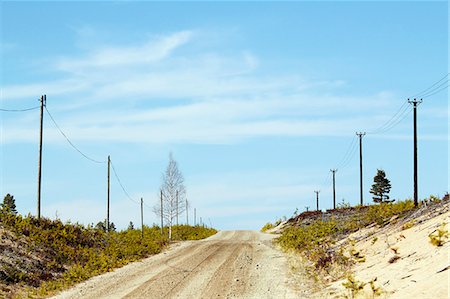 power line - Telephone poles along graveled road Foto de stock - Sin royalties Premium, Código: 6102-07843143