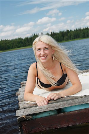 simsearch:6102-07843299,k - Young woman on log raft Stock Photo - Premium Royalty-Free, Code: 6102-07843132