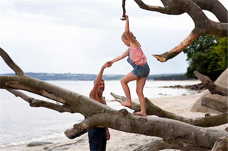 Father with daughter playing on beach Stock Photo - Premium Royalty-Free, Code: 6102-07843276