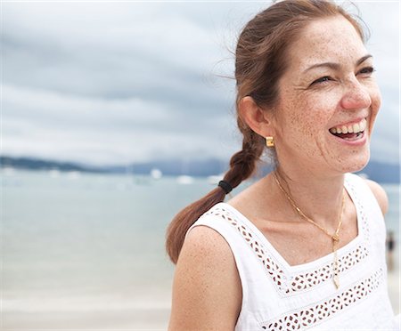 positiv - Smiling young woman on beach Foto de stock - Sin royalties Premium, Código: 6102-07843315