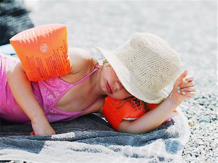 Girl sleeping on beach Stock Photo - Premium Royalty-Free, Code: 6102-07843419