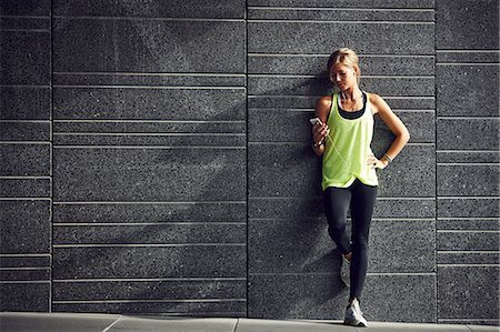 people smart phone workout not innovation not office - Young jogger with cell phone against grey wall Stock Photo - Premium Royalty-Free, Code: 6102-07843668