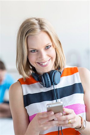 simsearch:6102-07843687,k - Smiling woman using cell phone Stock Photo - Premium Royalty-Free, Code: 6102-07843692