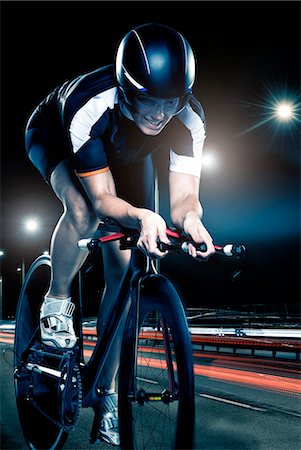 Woman cycling at night Stock Photo - Premium Royalty-Free, Code: 6102-07843625